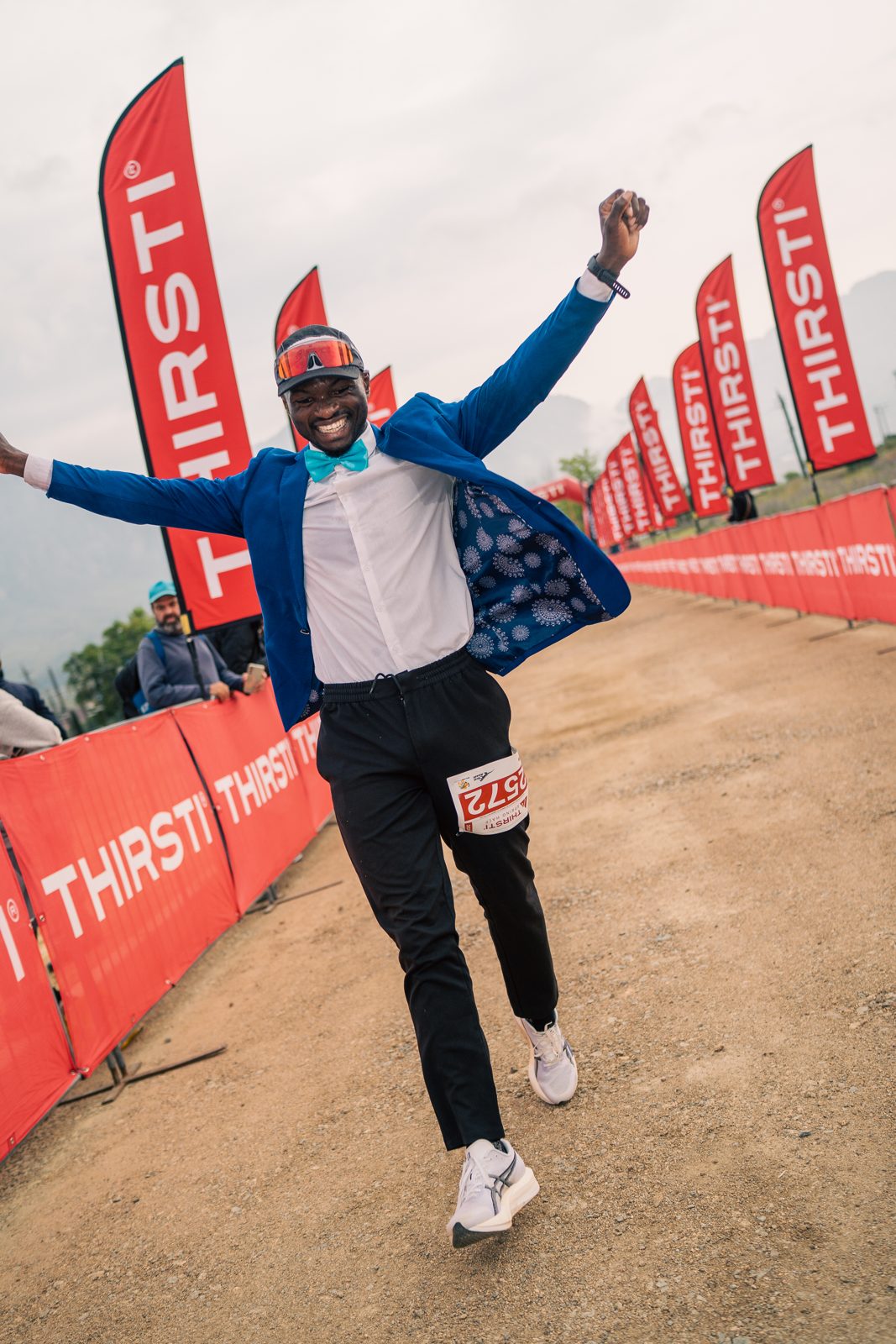 A runner celebrating in costume at the THIRSTI finish